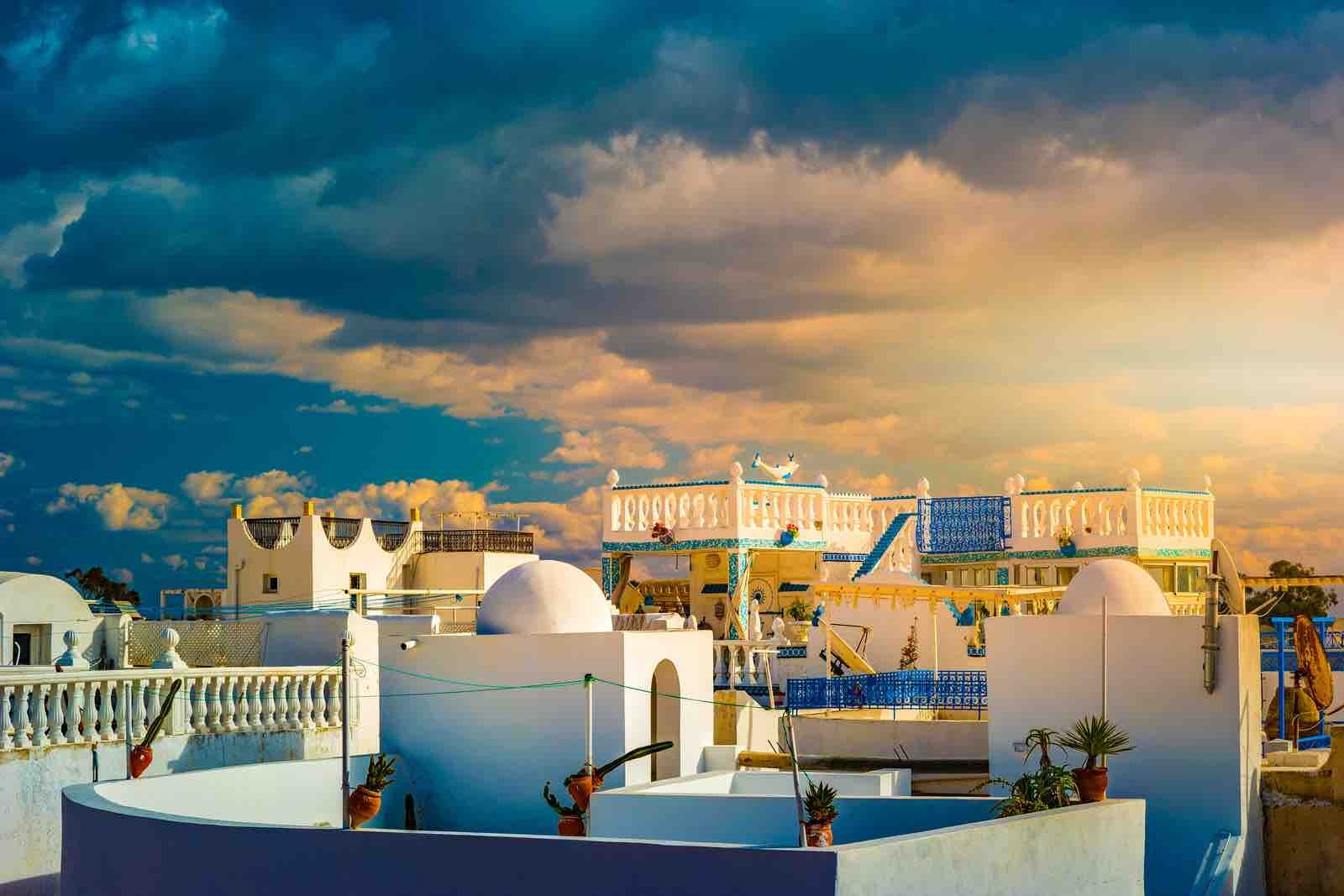 Hammamet, Tunisia. Image of architecture of old medina with dramatic sky at sunset time.